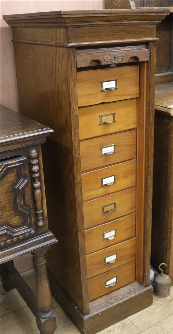 An oak tambour fronted chest containing watch parts H.116cm